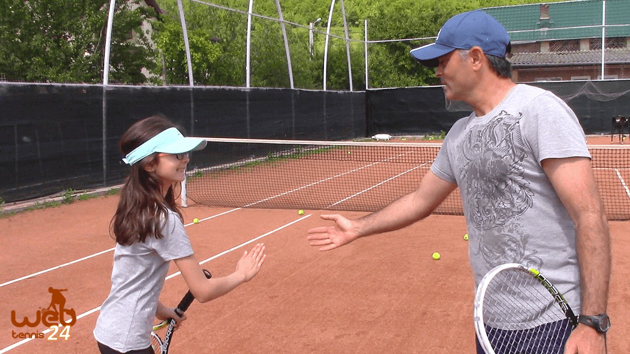 tennis coach teaches his daughter