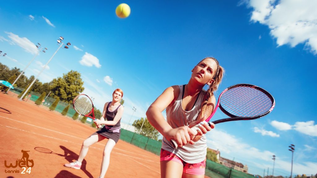 doubles tennis players at the net