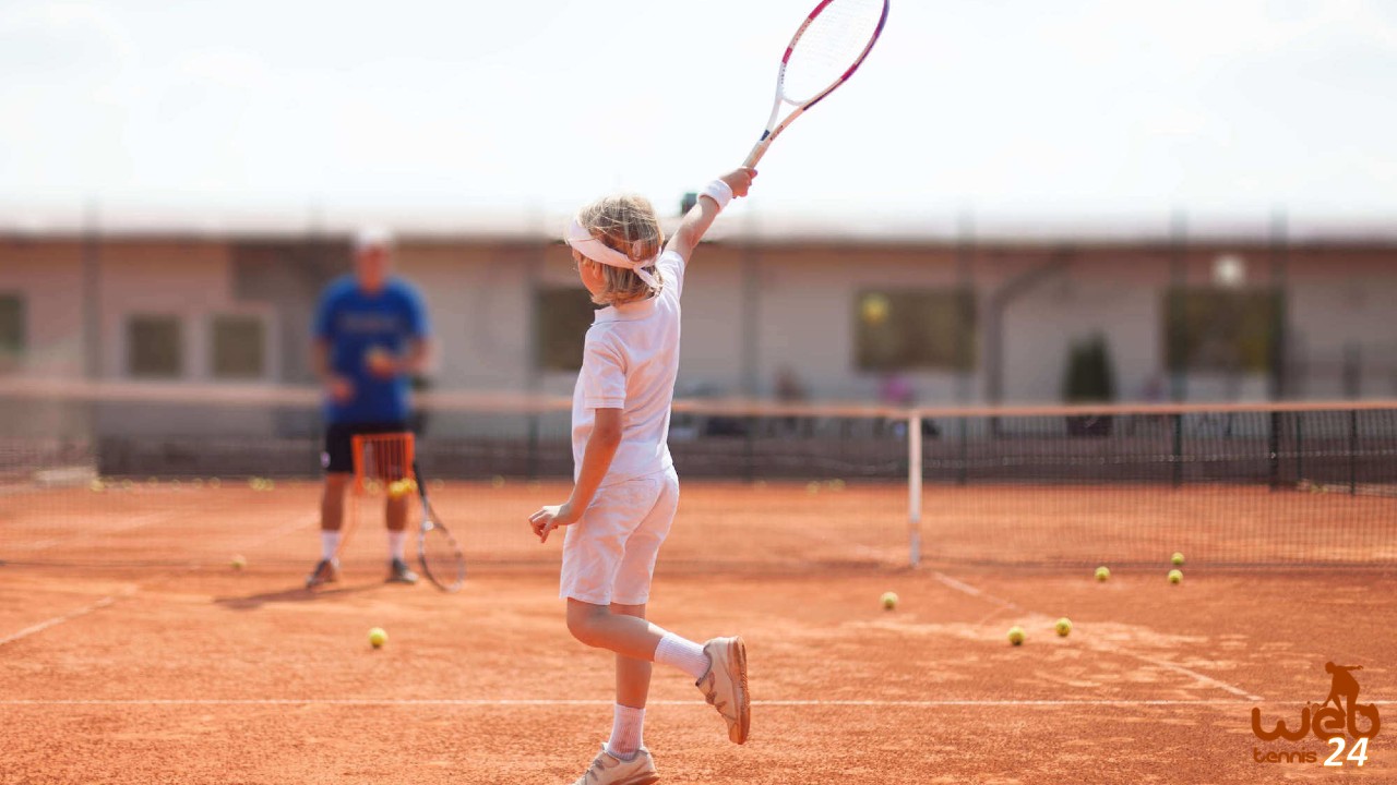 kid learning tennis