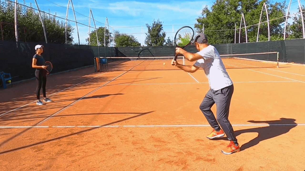 two-player tennis training practice with ball machine, pongbot