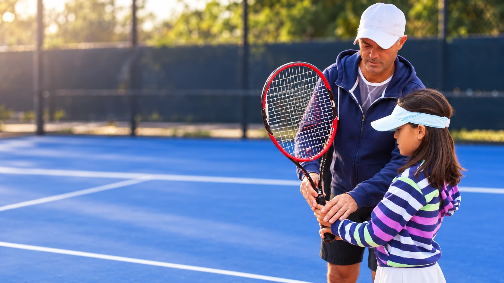 Coach Cosmin Miholca on a clay court with his daughter Bianca